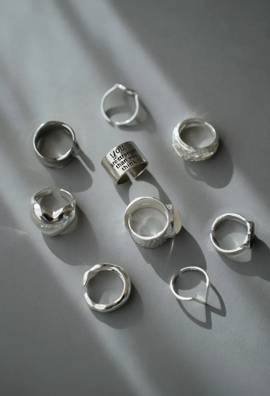 Silver Vibes rings on a grey stone